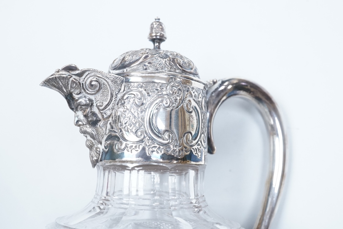 A late Victorian silver mounted cut glass claret jug, by Henry Wigfull, Sheffield, 1897, with mask spout and decorated with foliage and scrolls, height 27.5cm.